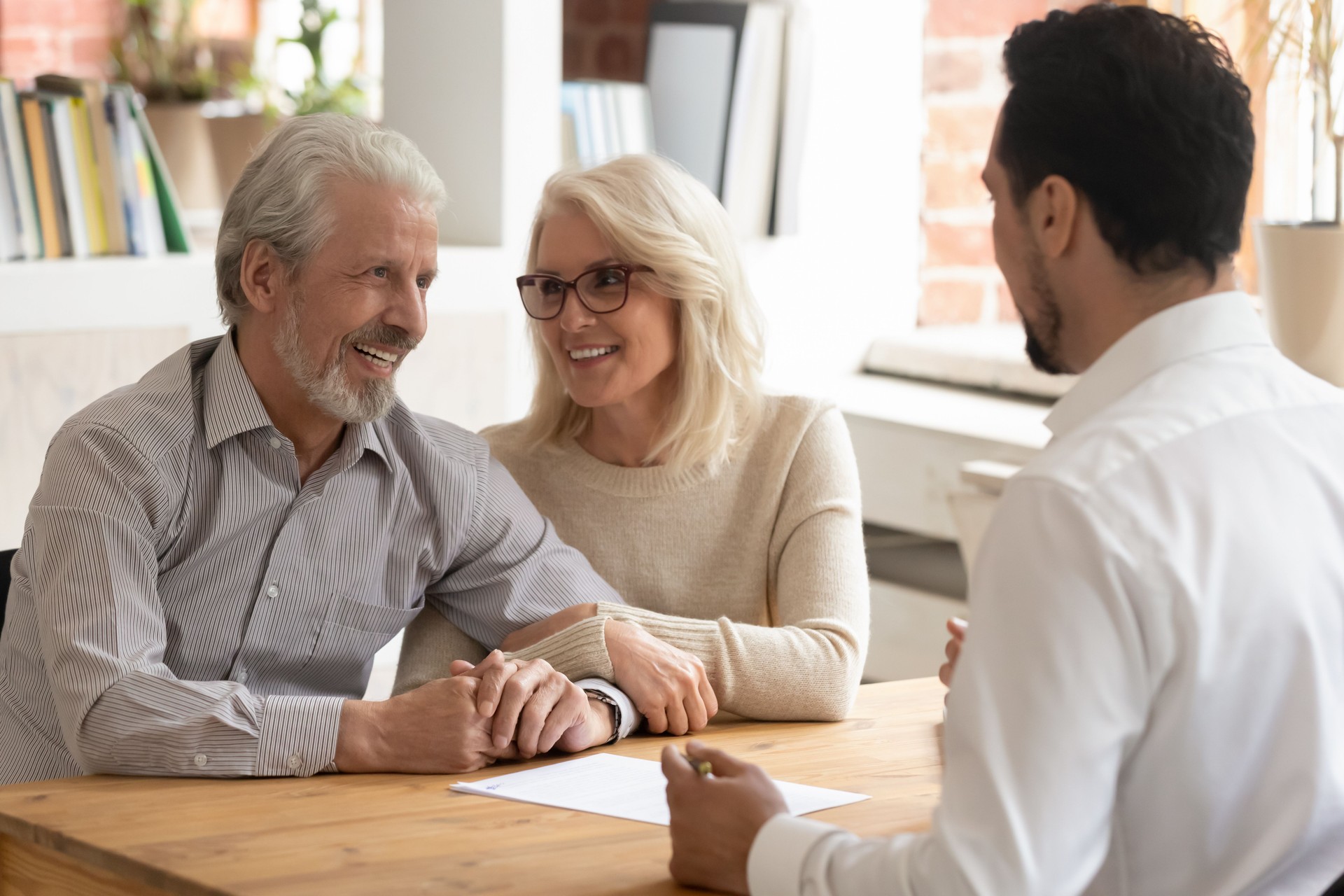 Elderly spouses during meeting with banker or real estate agent